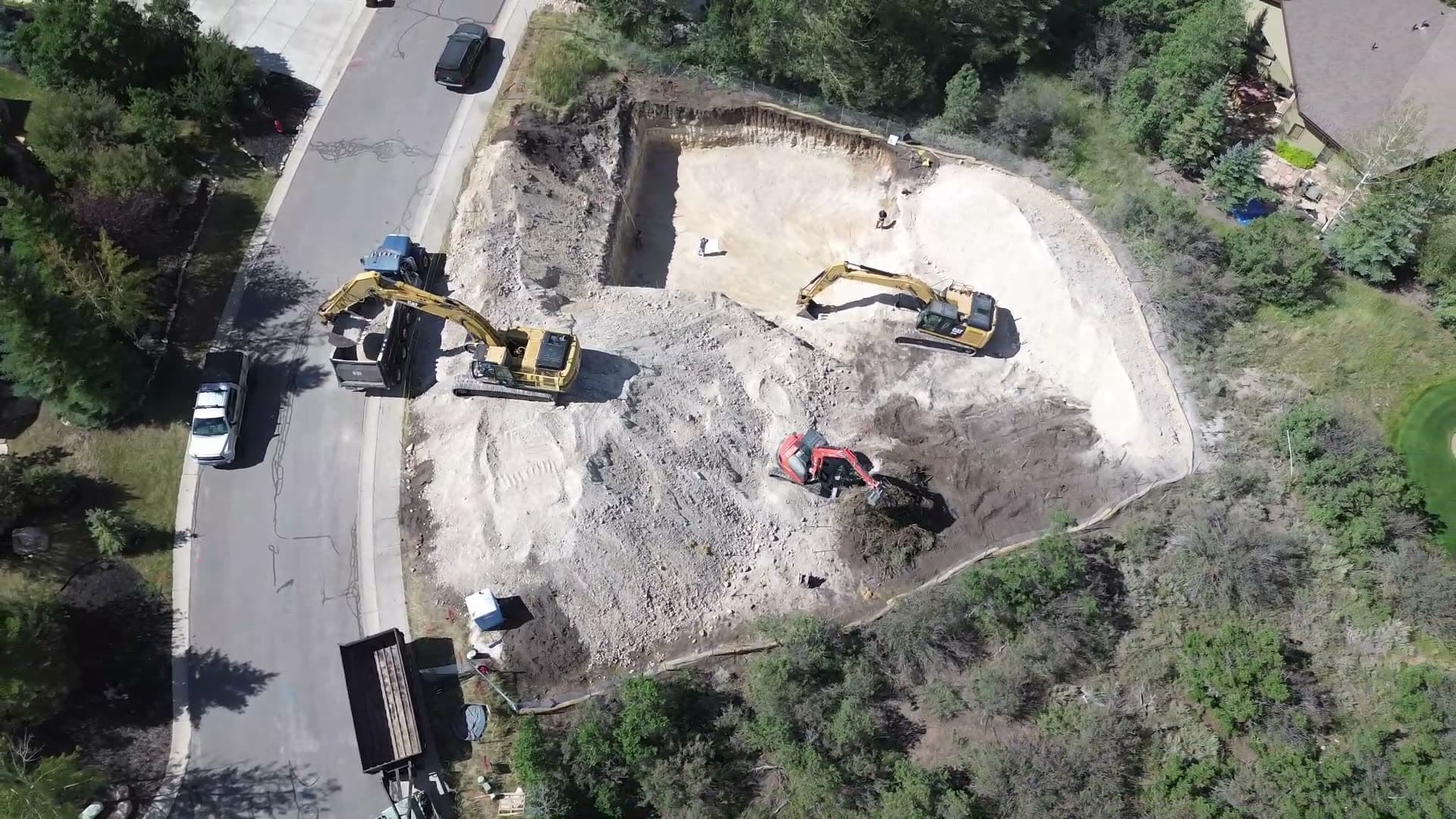 Drone view of Rico Construction excavators opening a building excavation in Park City, Utah.